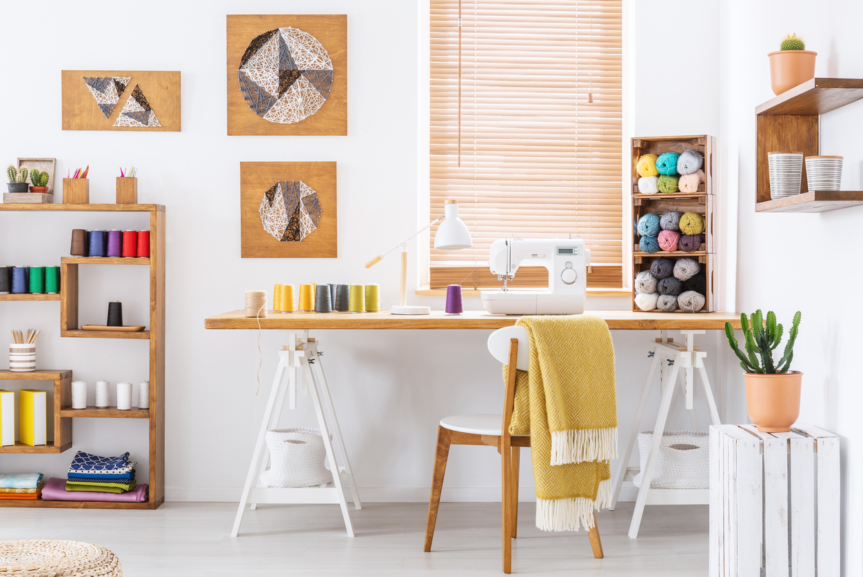 colorful room interior with a desk, sewing machine and thread