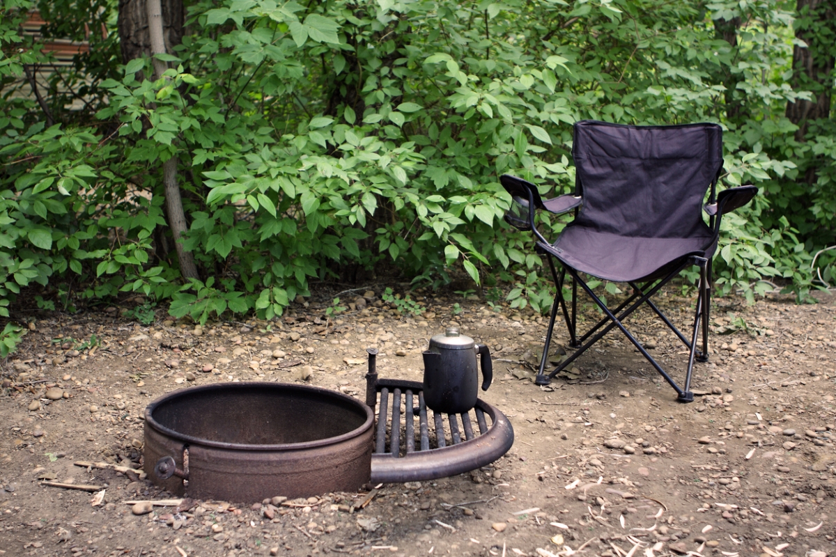 Camping chair next to empty fire pit