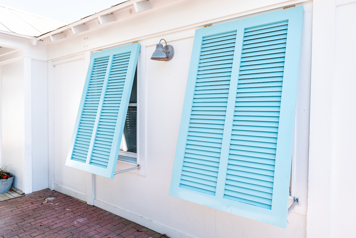 blue hurricane shutters installed on home exterior