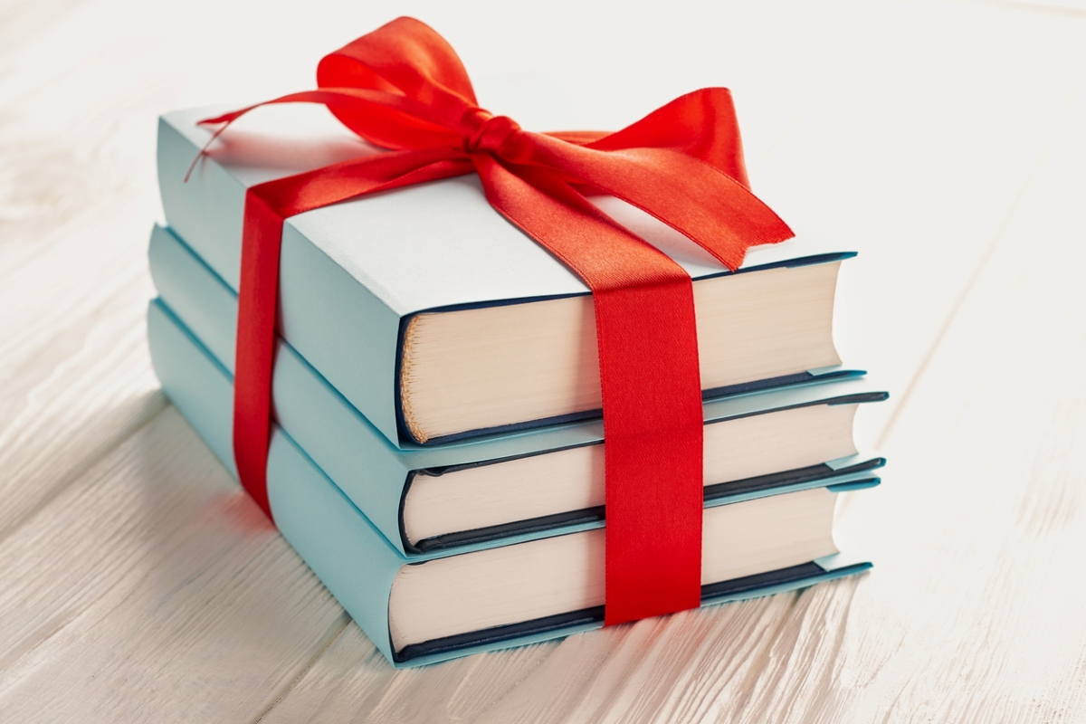 Three books wrapped in red bow