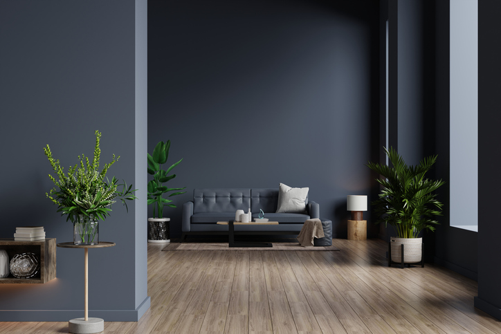 a-living-room-with-grey-matte-paint-on-walls-and-a-wood-floor-with-grey-and-brown-decor