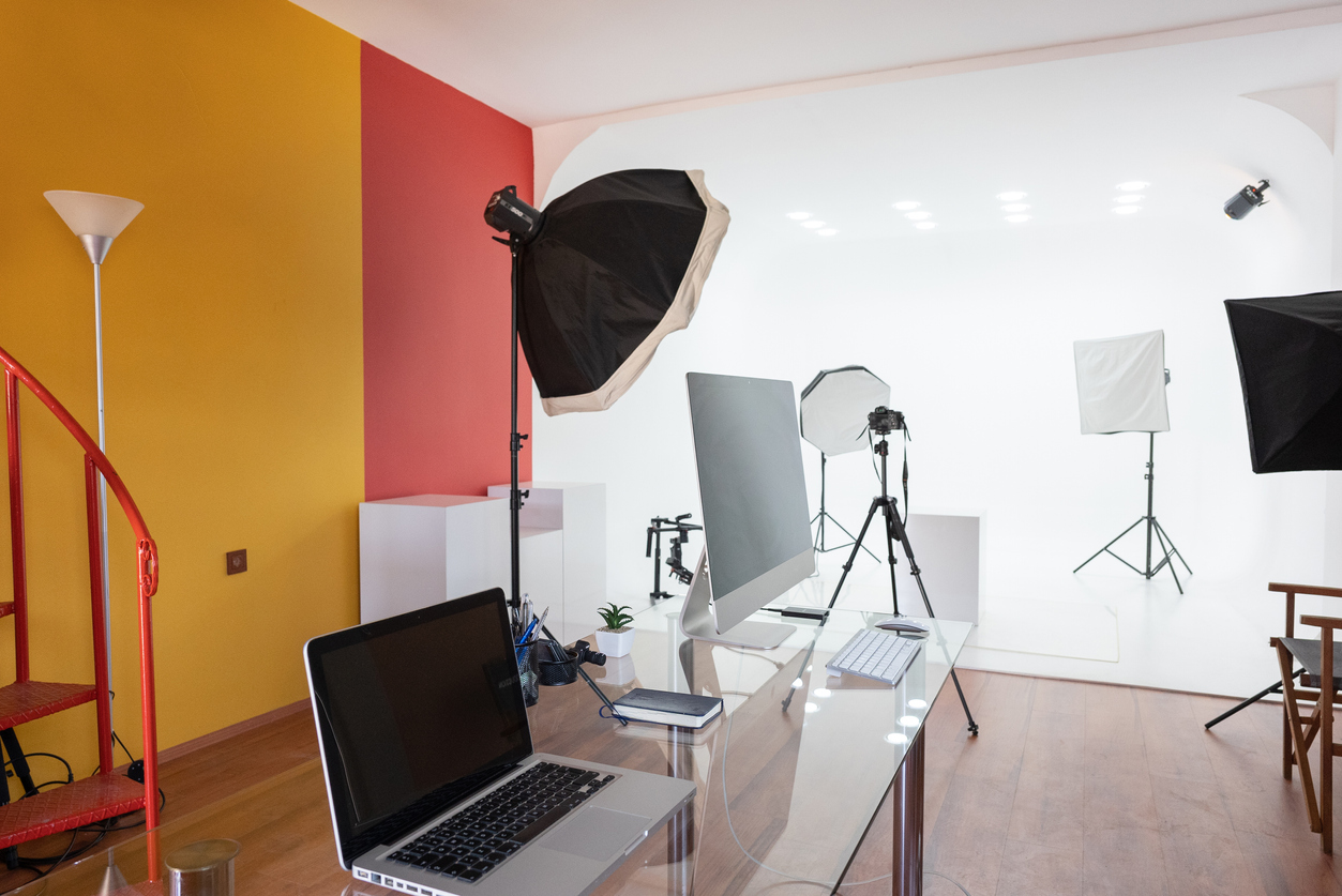 Modern Empty photo studio with photography lighting and computer.