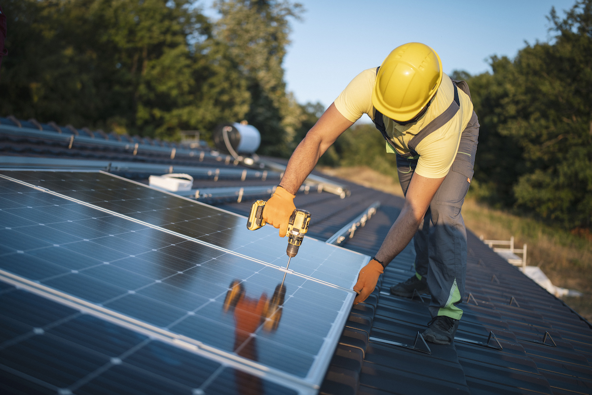 professional installing solar panels on a roof