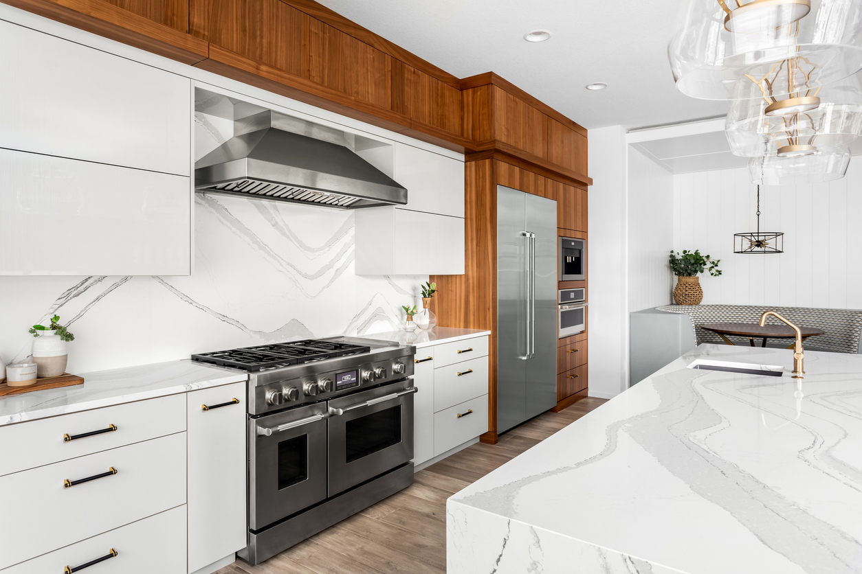 large luxury kitchen with white quartz island and white countertops