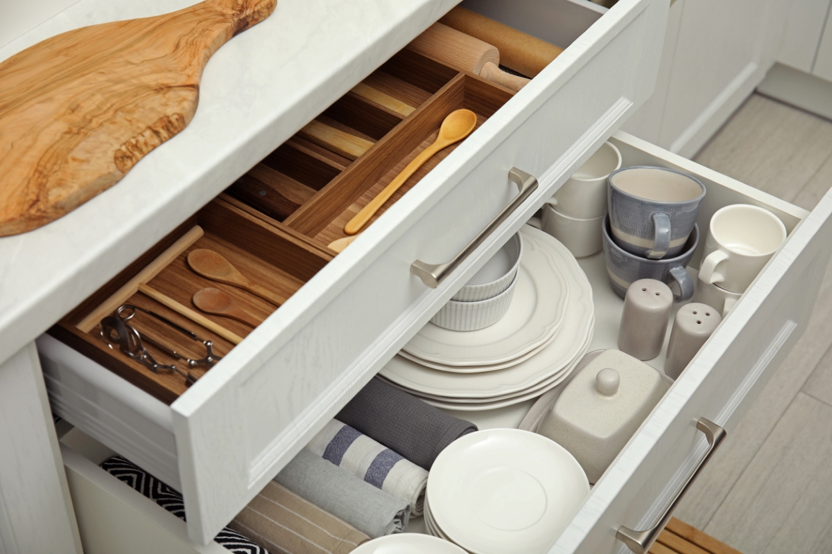 Open drawers with dishware and flatware
