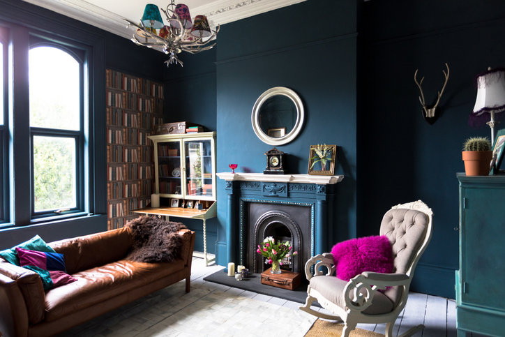 a-traditional-living-room-with-eclctic-decor-and-dark-teal-walls