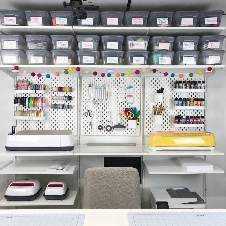 Crafting area with pegboard, desk, and organized bins
