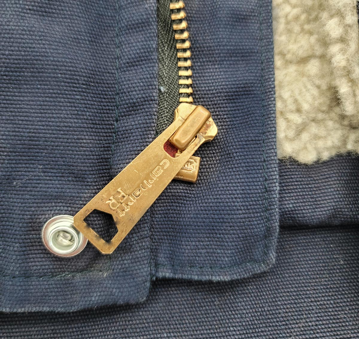 A close-up of the zipper on the Carhartt Flame-Resistant Sherpa-Lined Vest