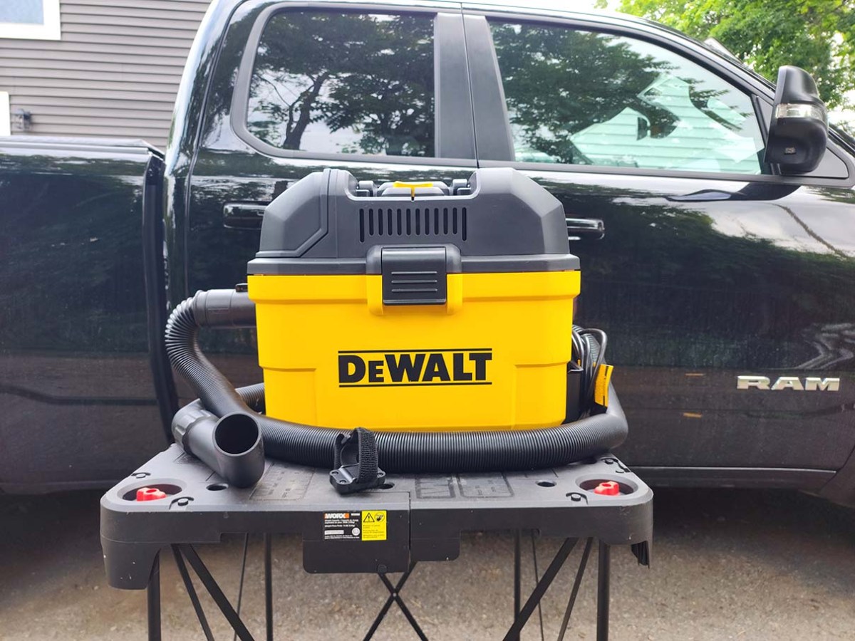 DeWalt Wall-Mounted Wet Dry Vacuum on table outside in front of truck