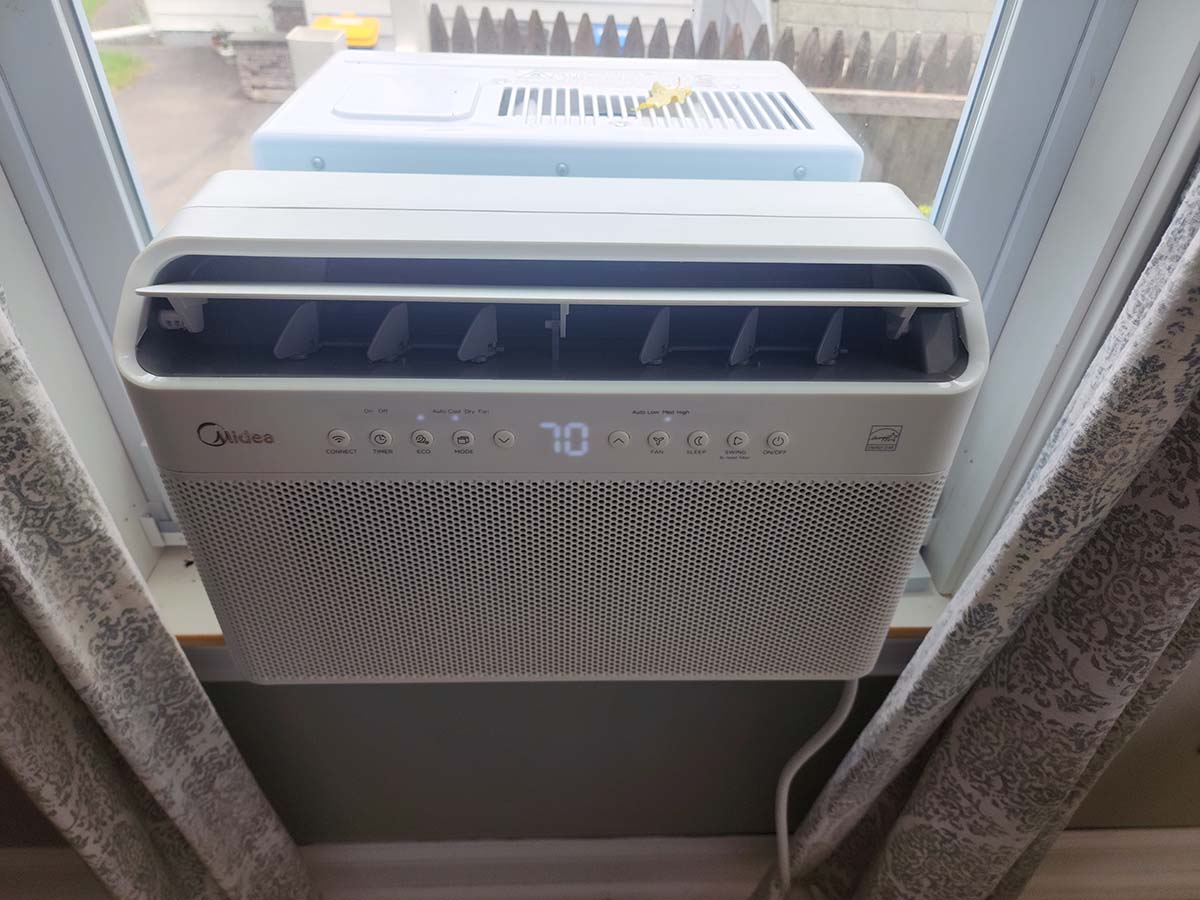 A photo looking down at the Midea U-shaped air conditioner after installation to show that part of the unit is indoors and part is outdoors