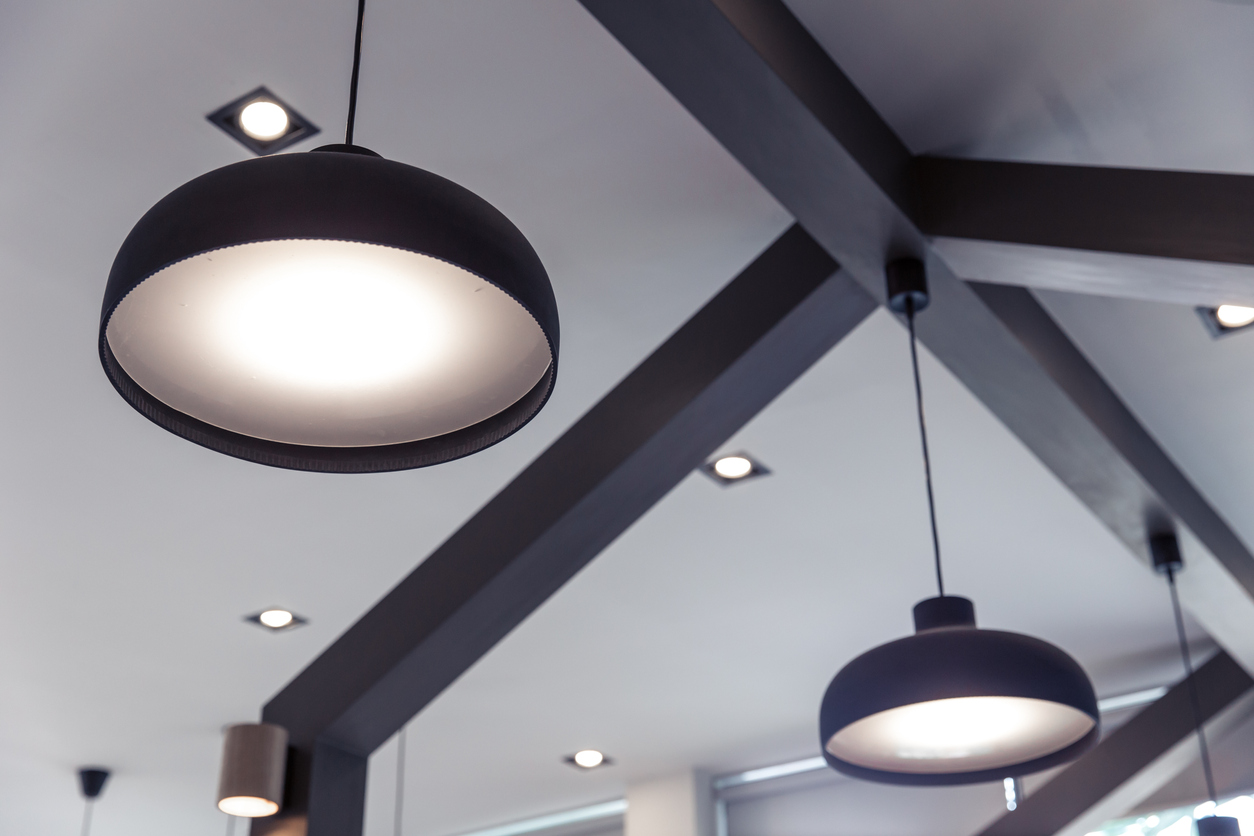 Lights hanging from ceiling with dark painted trim.