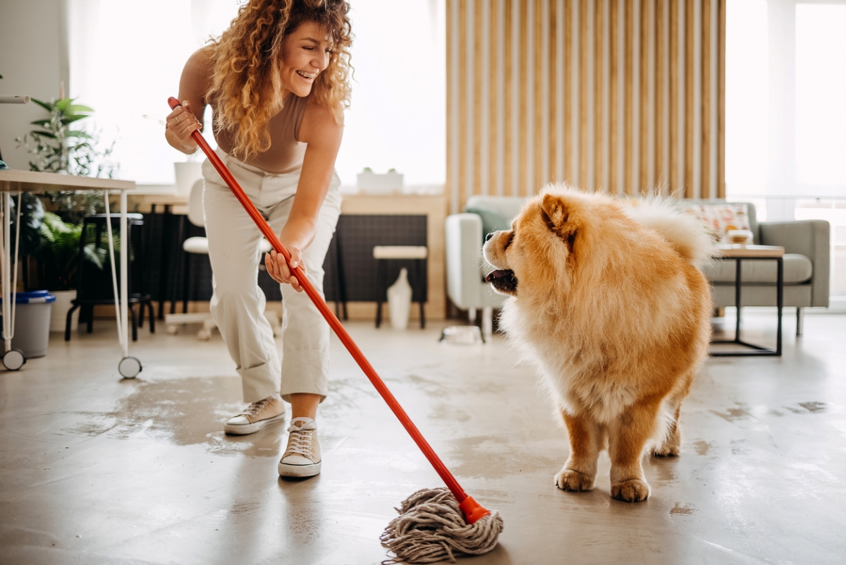 Woman cleaning floor after pet