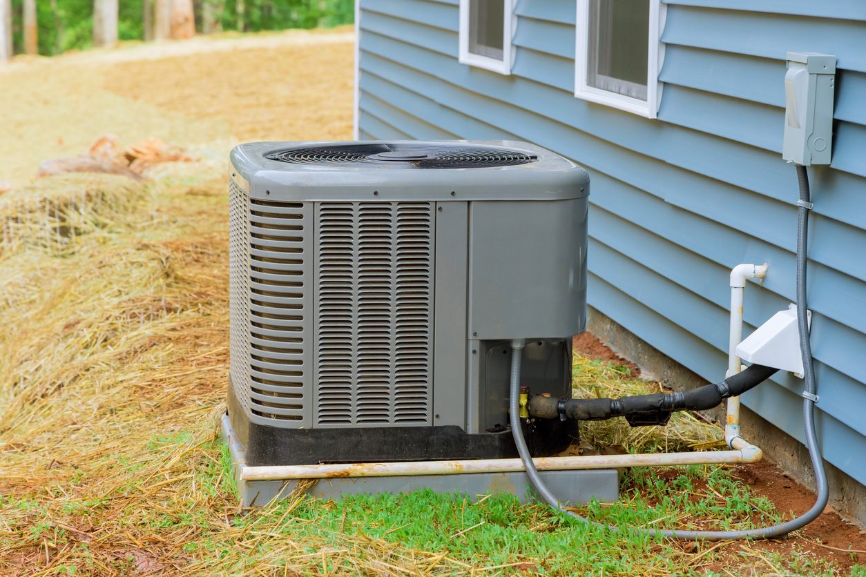 air conditioner outside behind house