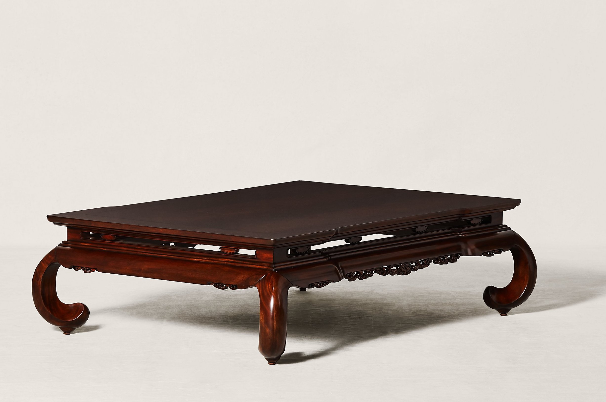 an ornate wooden coffee table by Ralph Lauren