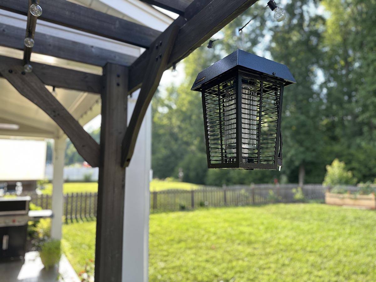 Flowtron BK40DK Electronic Insect Killer hanging from gray pergola