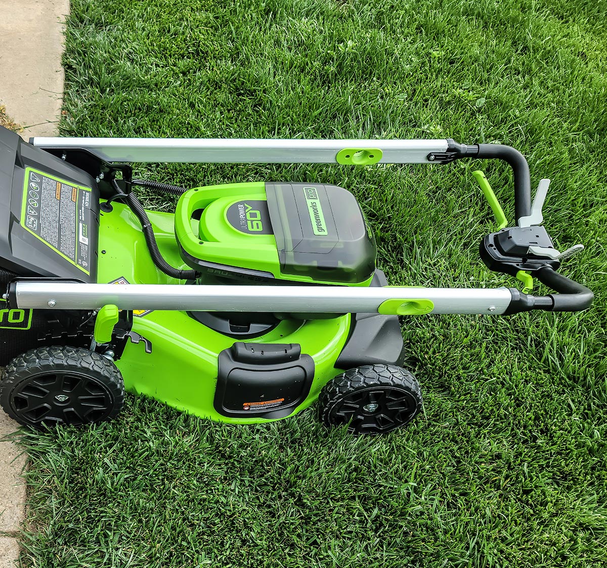 The handle on the Greenworks Pro 60V 21-Inch Battery Lawn Mower folded over for storage