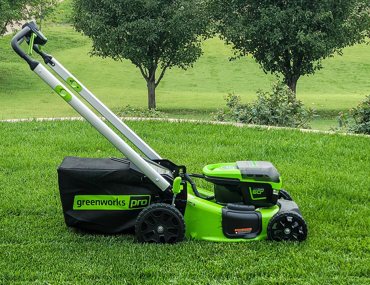 The Greenworks Pro 60V 21-Inch Battery Lawn Mower sitting on a bright green lawn
