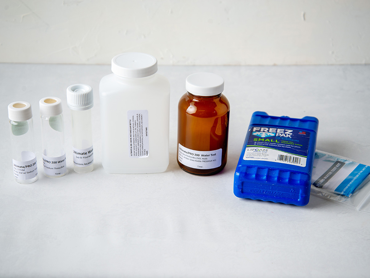 Safe Home Ultimate Drinking Water Test Kit vials, bottles, and freezer pack on countertop