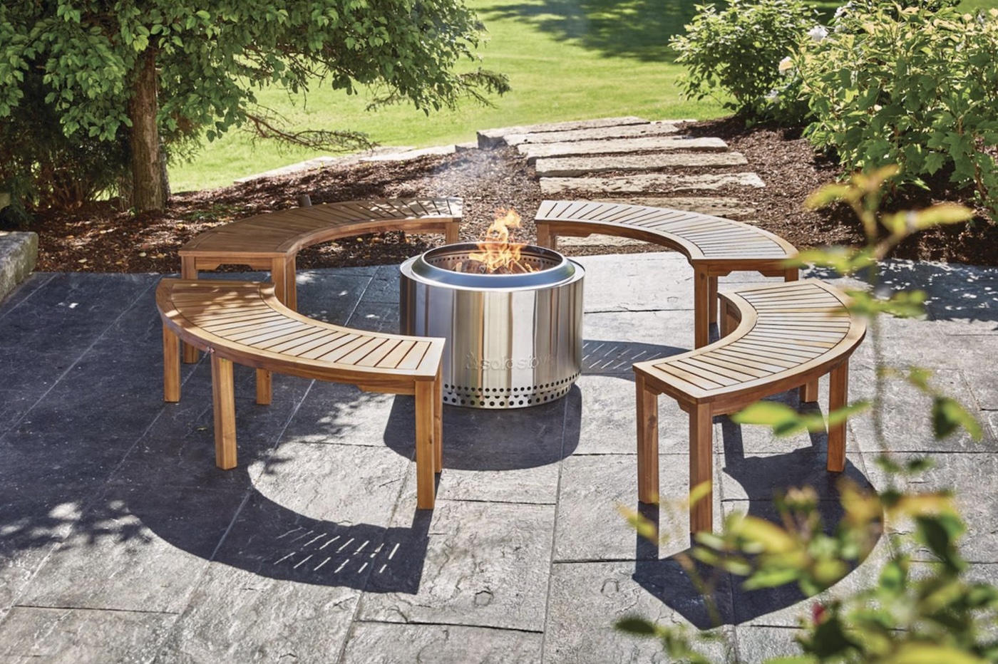 Curved garden benches surrounding an outdoor fire pit.