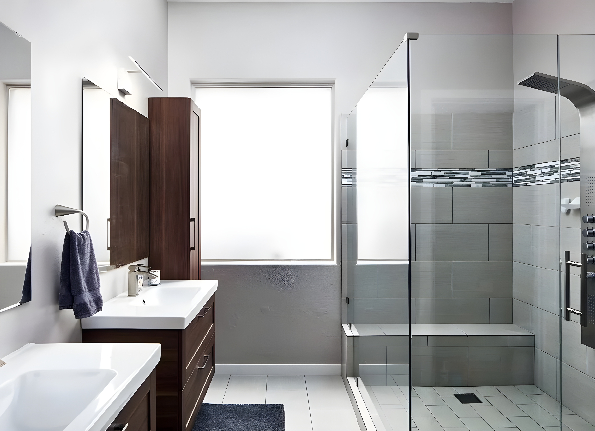 Minimalist bathroom featuring large subway tile with a strip of black-and-white piano tile in the shower