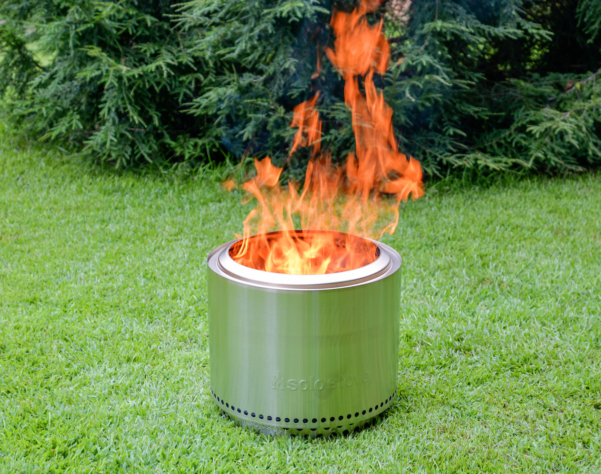 Solo stove showing flames in a backyard