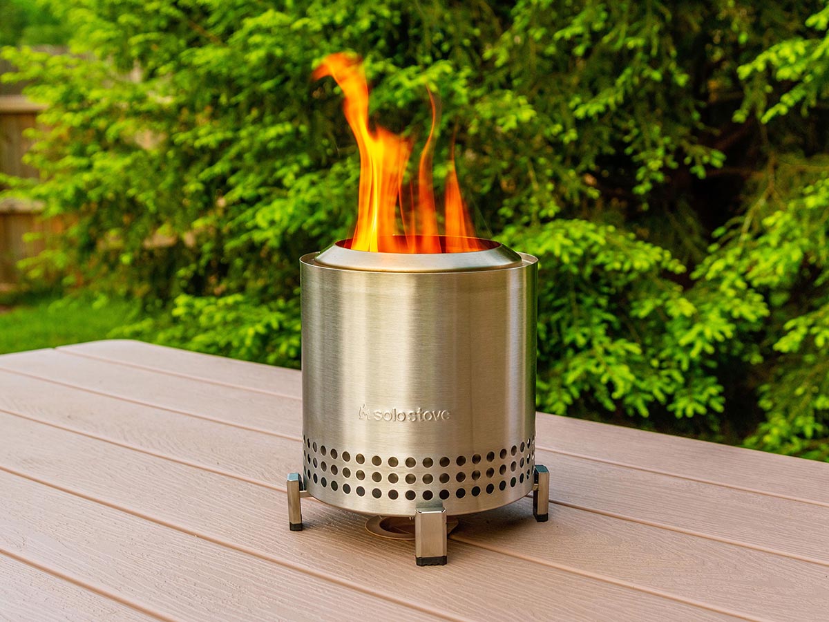The Solo Stove Mesa XL set up and burning a fire on a tabletop