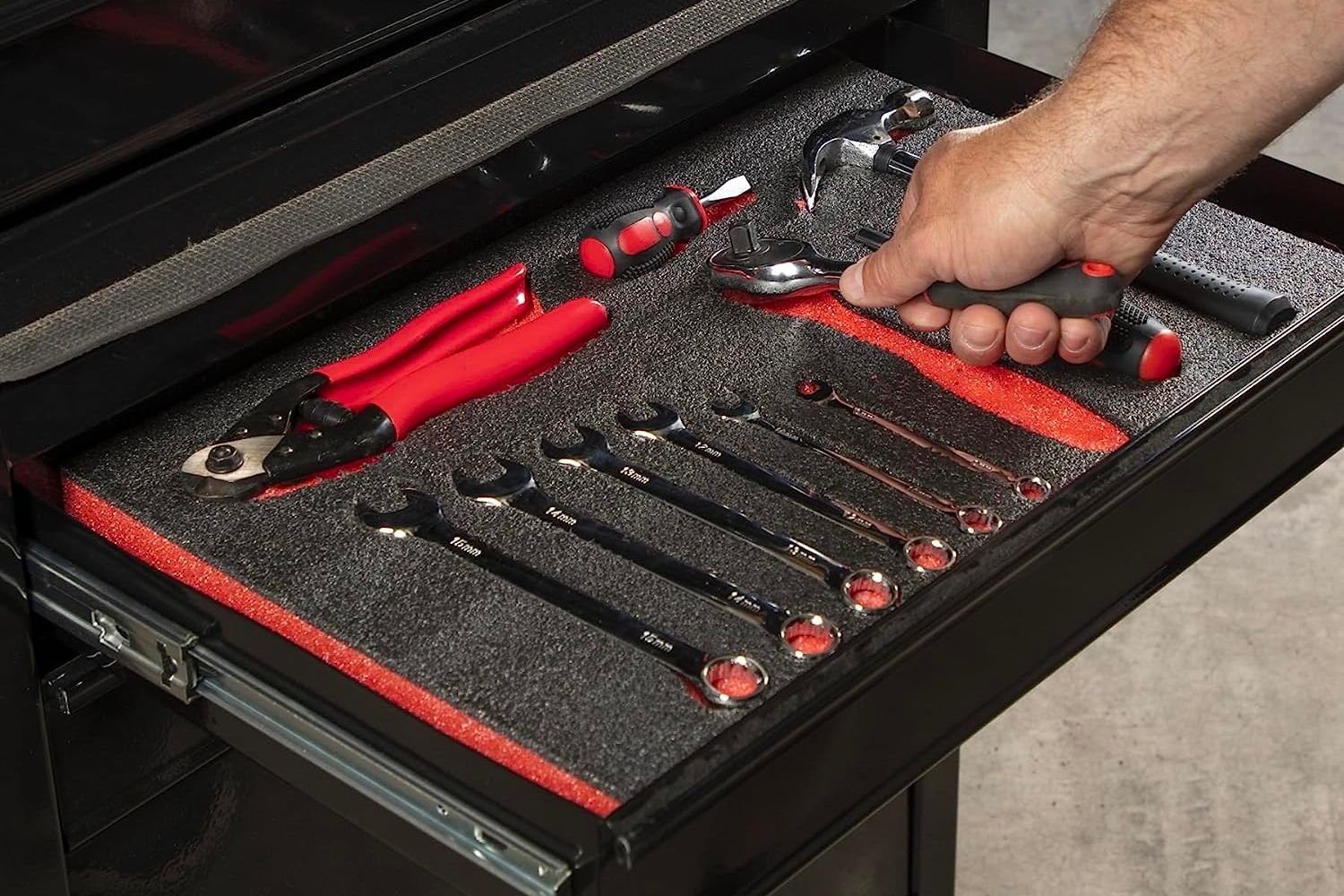A person removing a tool from the best tool box organizer option