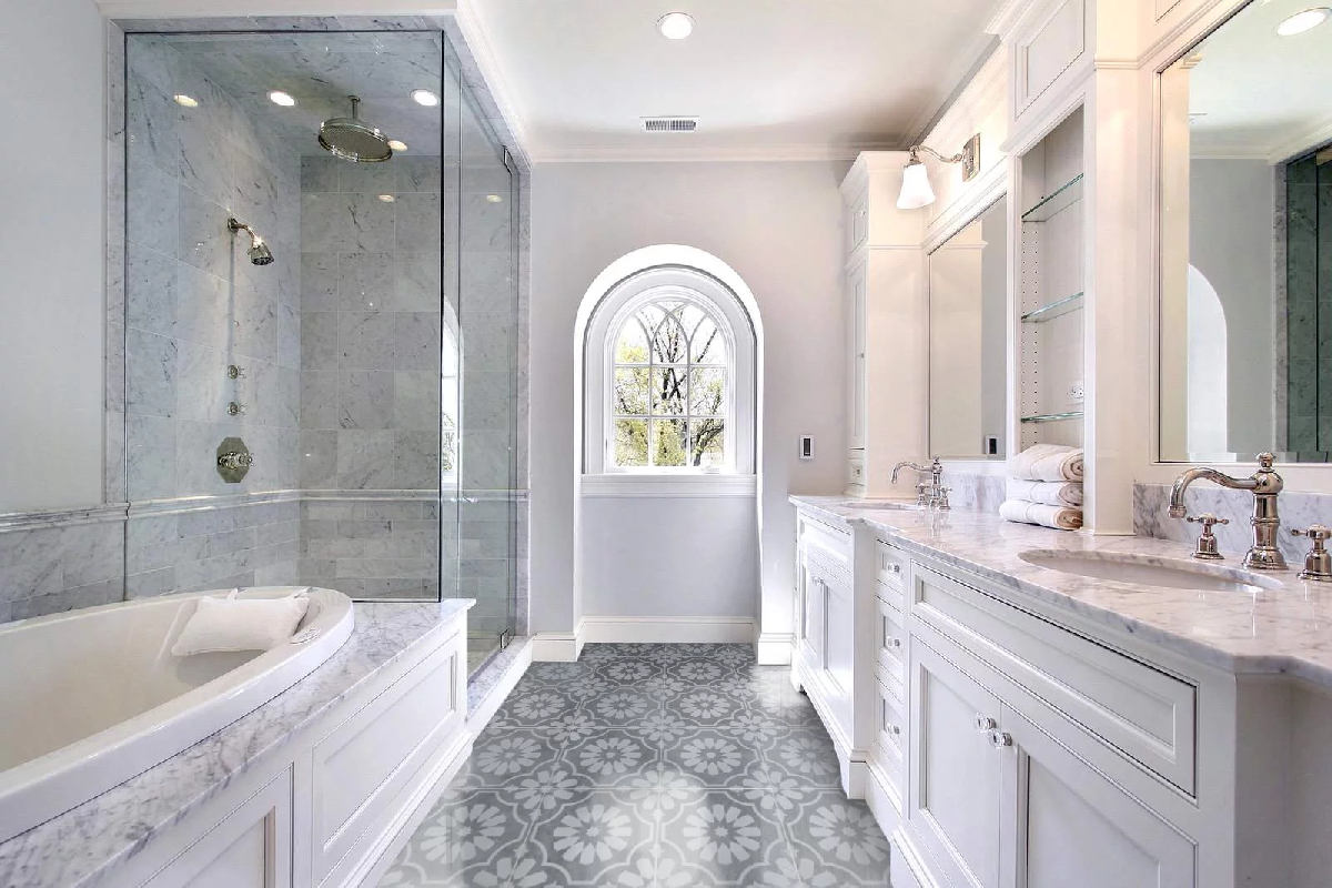 Luxury bathroom with a garden tub, glass shower, and gray-and-white marble shower tile