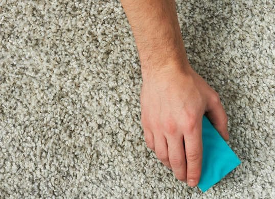 close up of hand cleaning carpet