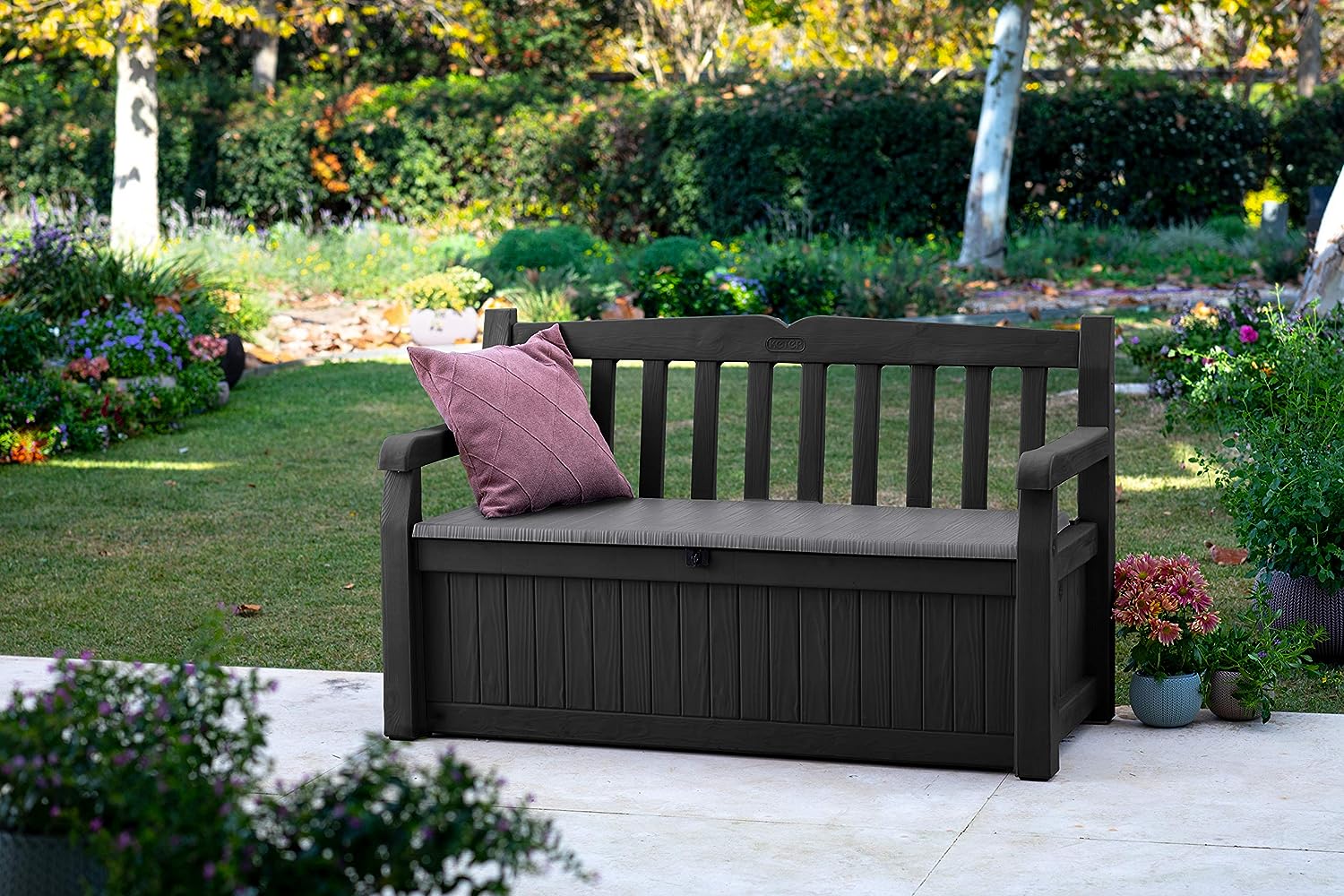 Dark wooden garden bench with storage compartment.