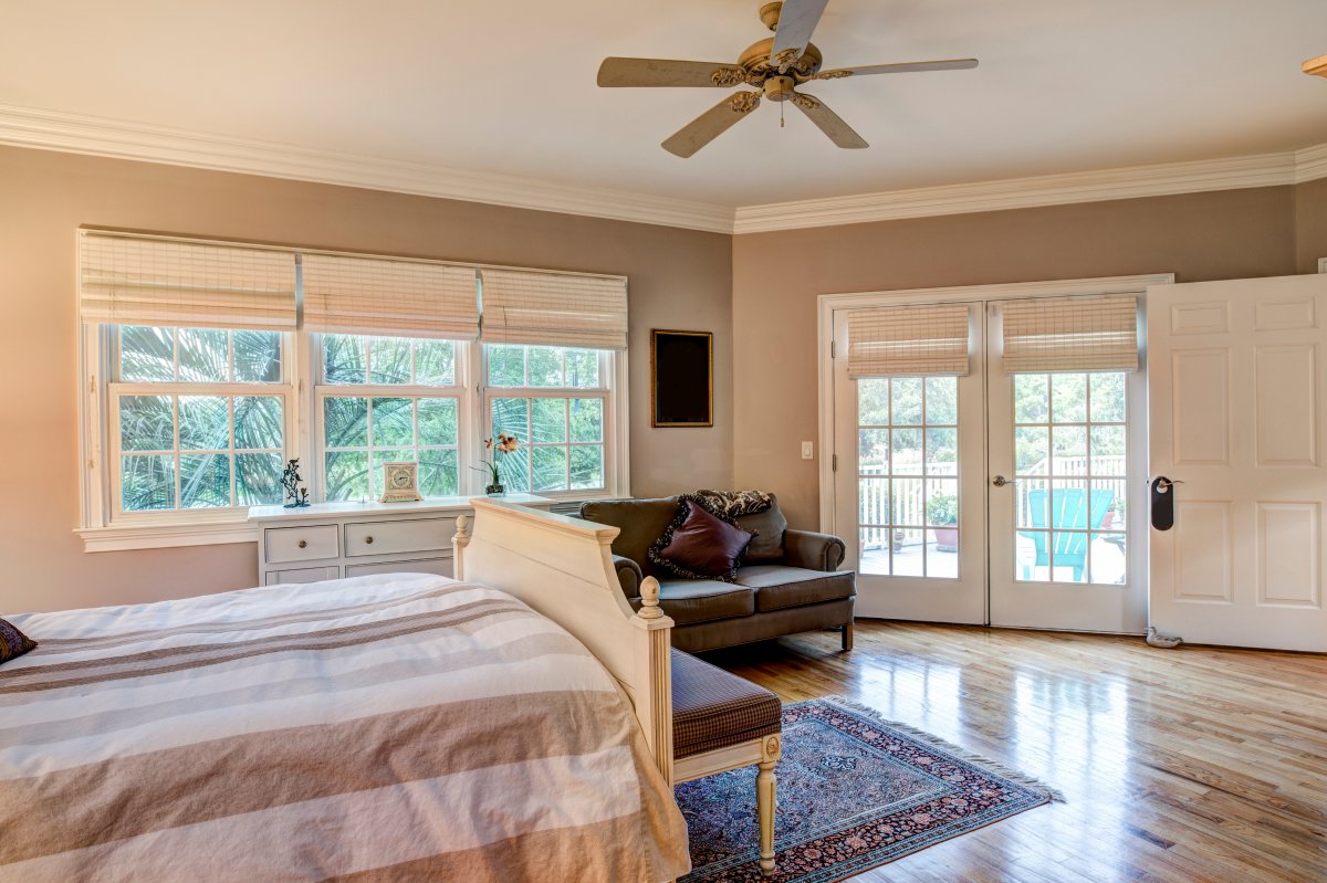 Tasteful bedroom interior with hard wood floors and French doors.