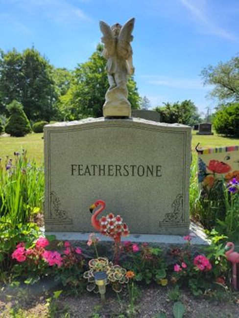 featherstone family grave with a flamingo in front along with flowers