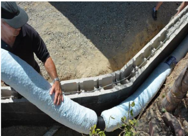 Man installing piping in a French drain.