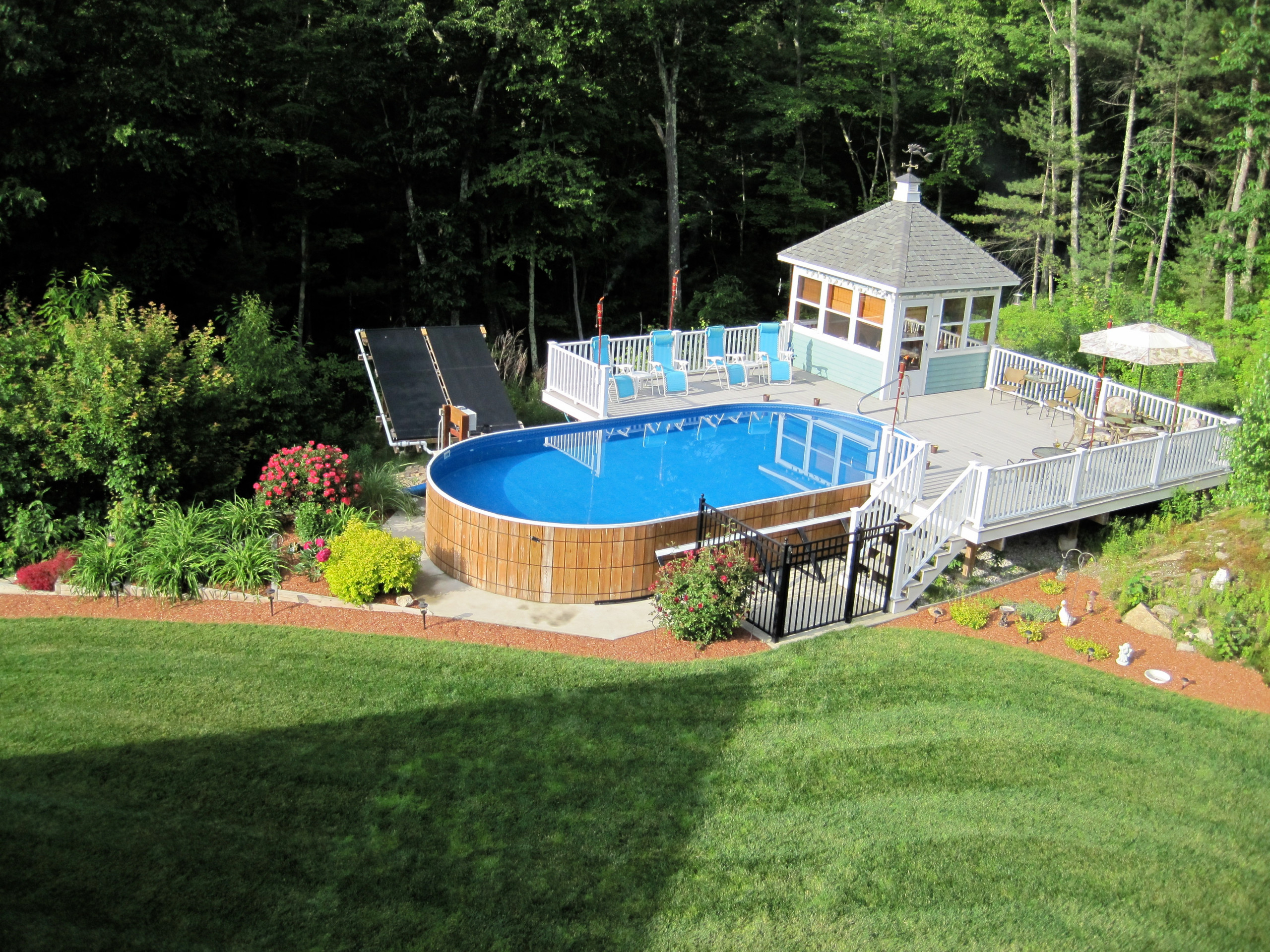 Overhead shot of an above ground pool with a pool house