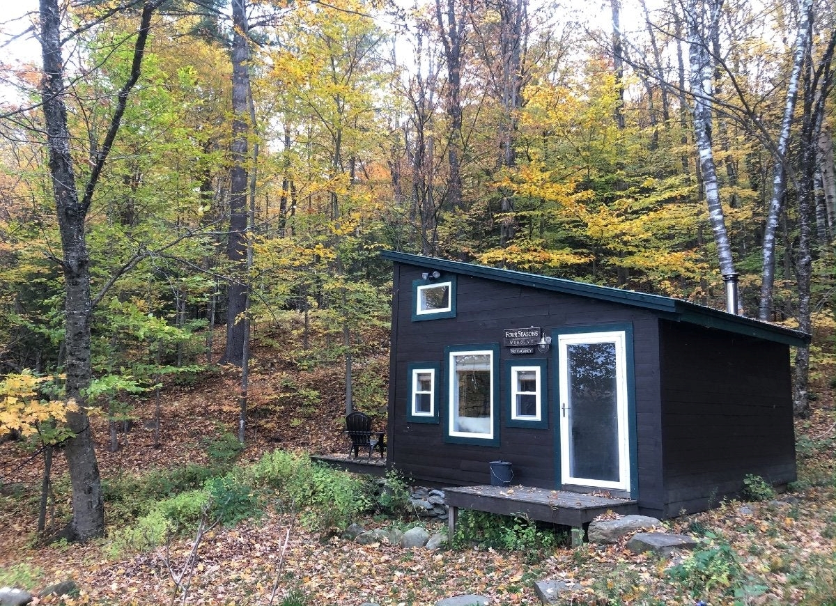 Dark colored tiny home in the woods