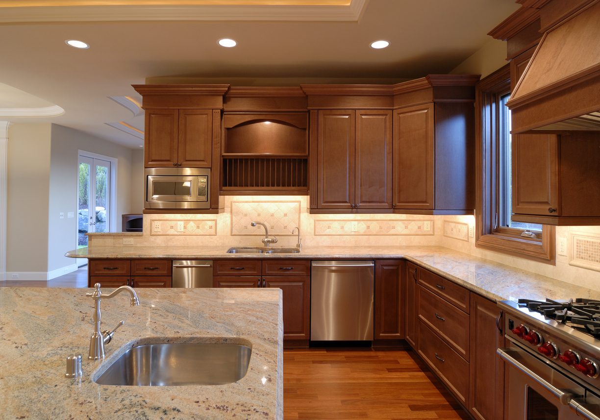 large kitchen with a long island and long countertops and cabinets