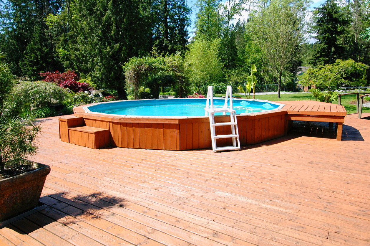 Above ground pool built into a wooden deck