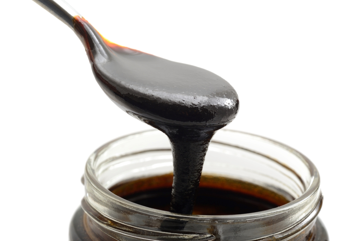 Spoonful of molasses from jar