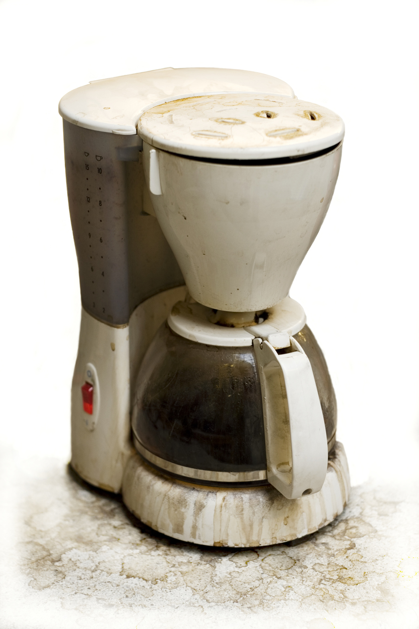 A very used and dirty coffee machine isolated.