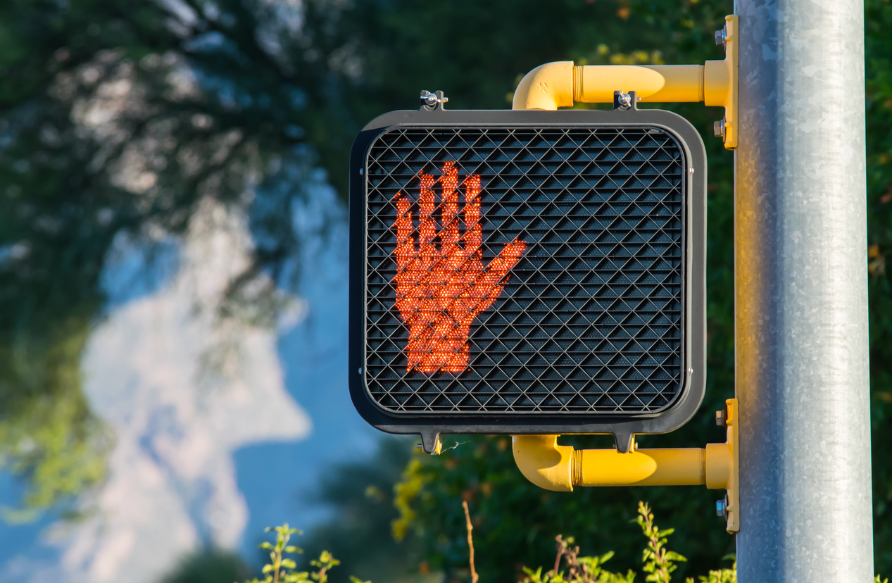 close up on don't walk sign displaying red hand