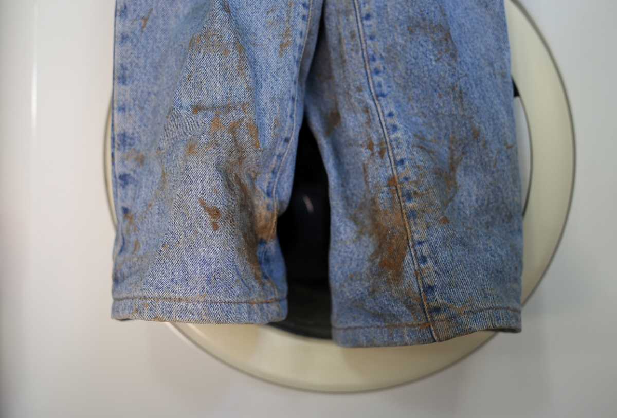 Muddy jeans on washer