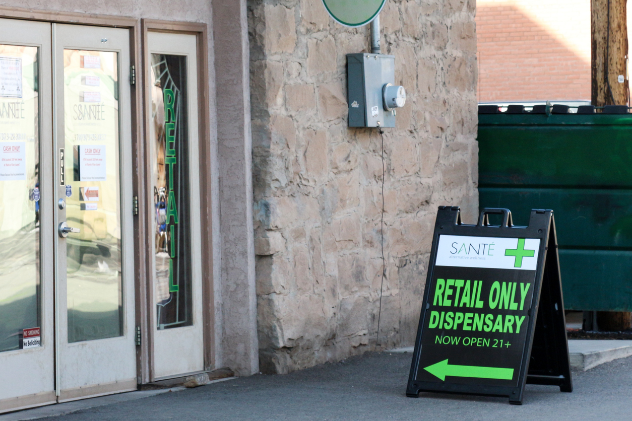 store front with sign outside advertising marijuana dispensary