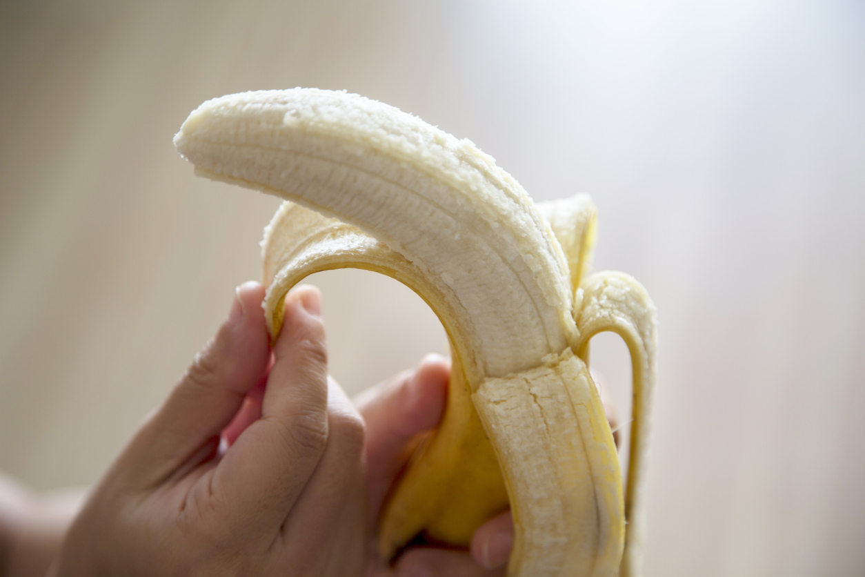 close up on hand peeling a banana