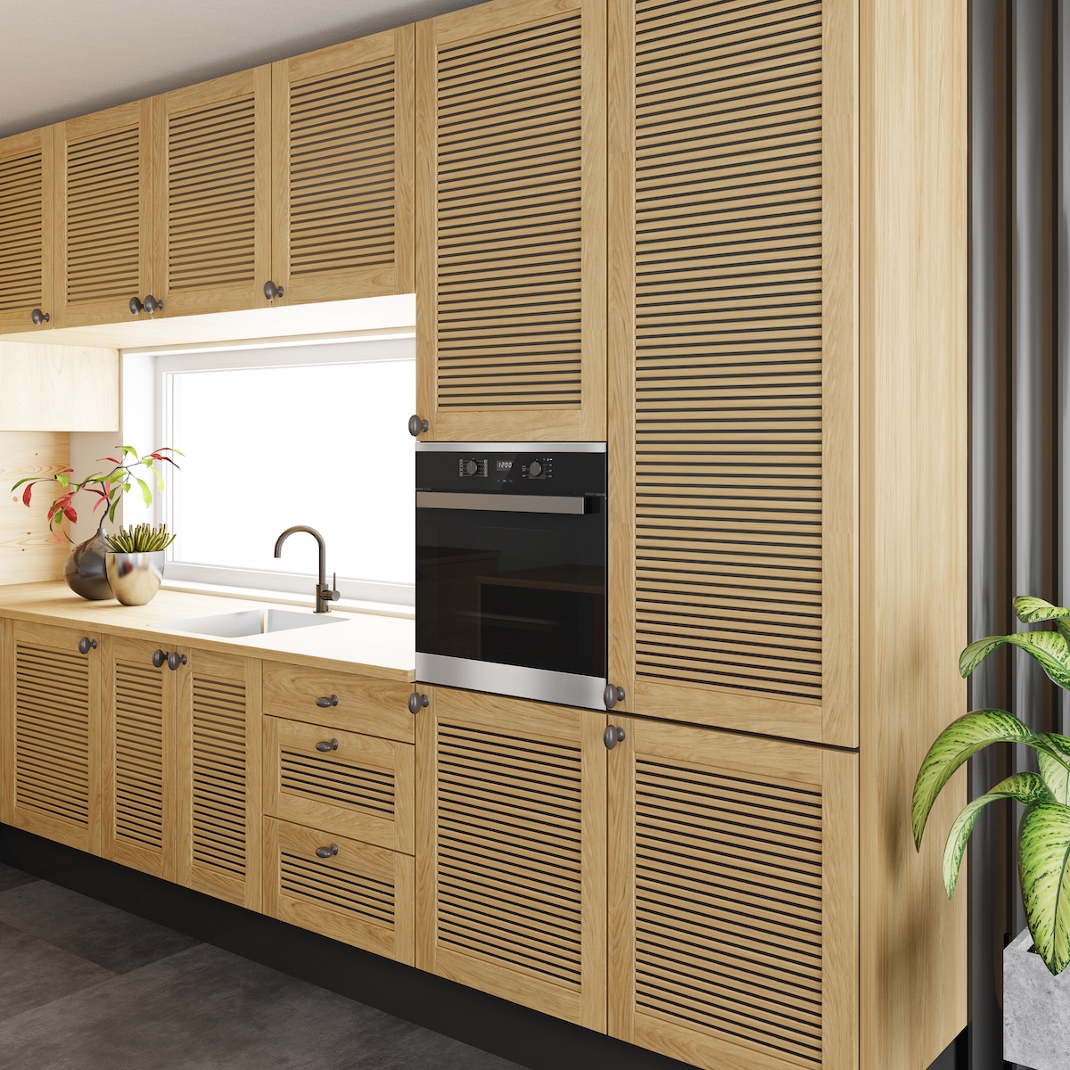 Minimalist apartment galley kitchen with oak louvered cabinets against one wall.