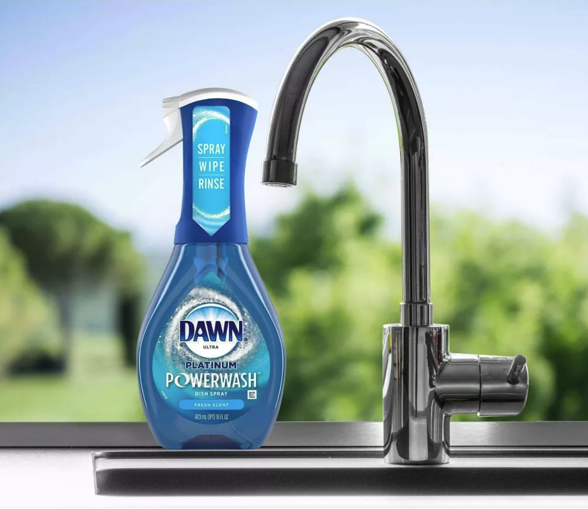 product shot of Dawn Power Wash bottle sitting next to kitchen sink in front of window