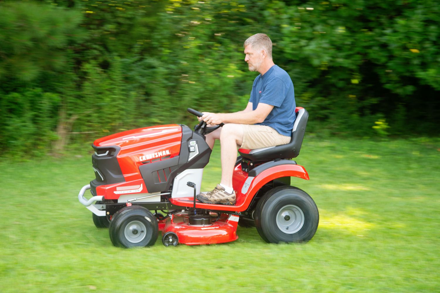 A person mowing a large lawn using the Craftsman Battery Riding mower