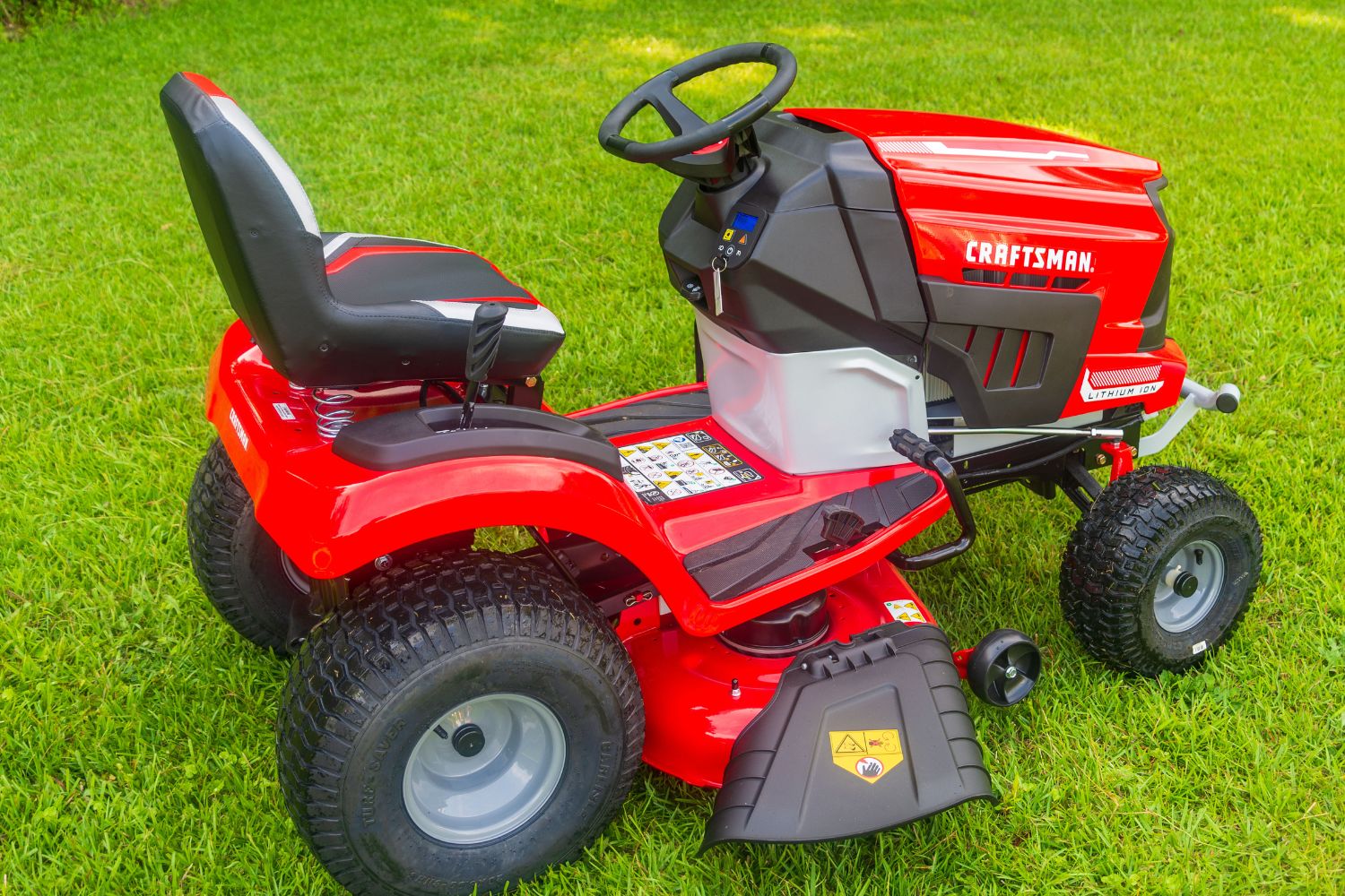 The Craftsman battery riding mower parked on a freshly mowed lawn