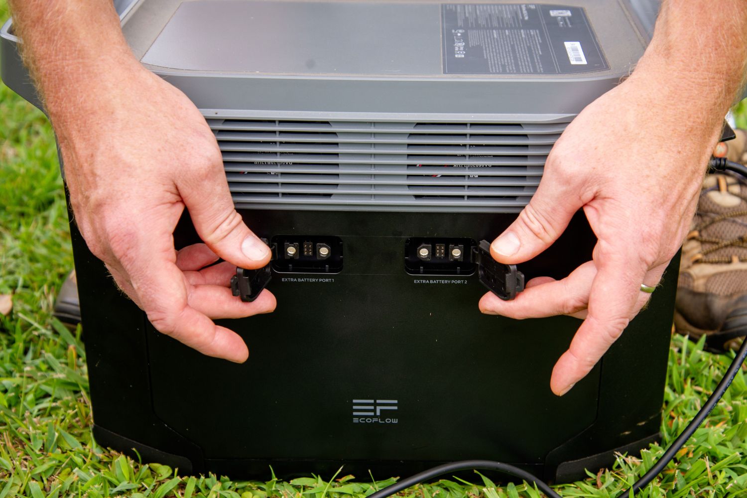 A person holding open the input doors on the EcoFlor Delta Max 2 solar generator