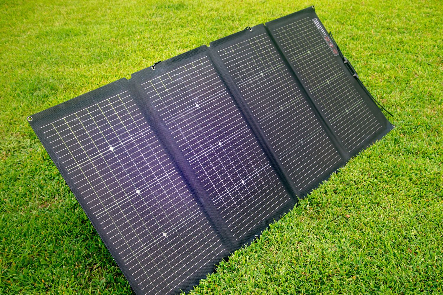 The solar panel of the EcoFlow Delta 2 Max solar generator set up in a yard