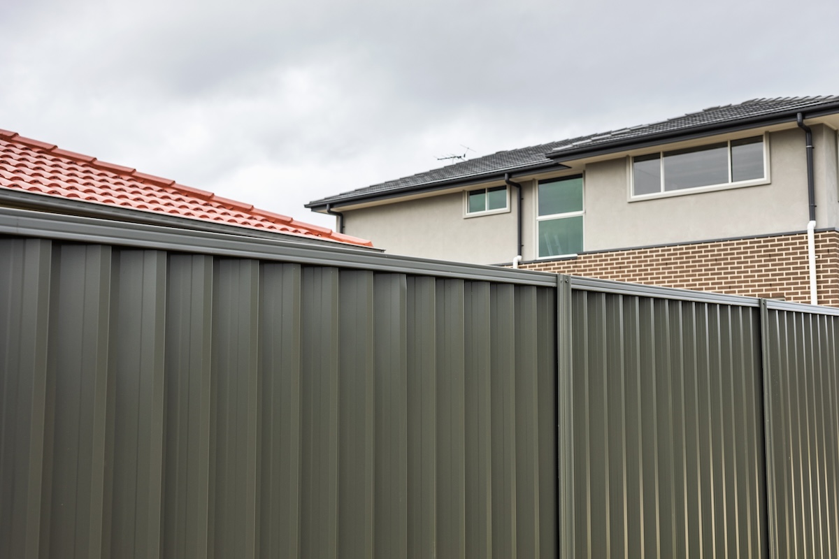 A corrugated metal fence for backyard privacy.